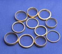 Lot 185 - Ten 18ct. yellow gold wedding bands, of plain...