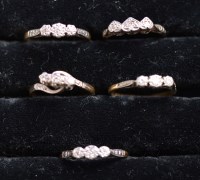 Lot 220 - Five diamond rings, each set three diamonds in...