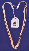 Lot 289 - An 18ct. yellow gold necklace, of triple row...