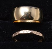 Lot 296 - An 18ct. yellow gold broad wedding band,...