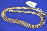 Lot 302 - A 9ct. yellow gold necklace, of chevron and...