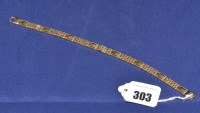 Lot 303 - A 9ct. yellow gold gate-link pattern bracelet,...