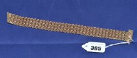 Lot 305 - A 9ct. yellow gold bangle, of chevron links...