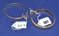 Lot 307 - A 9ct. yellow gold bangle, half engraved with...
