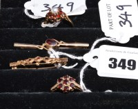 Lot 349 - A garnet cluster ring on 9ct. yellow gold...
