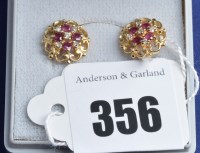 Lot 356 - A pair of ruby, diamond and 9ct. yellow gold...