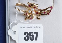 Lot 357 - A cultured pearl, ruby and 9ct. yellow gold...