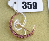 Lot 359 - A ruby set 9ct. yellow gold crescent pattern...