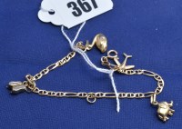 Lot 367 - A yellow metal charm bracelet, stamped '9k', 3....