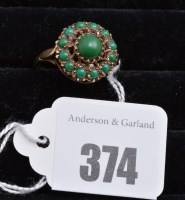 Lot 374 - A turquoise cluster ring on 9ct. yellow gold...
