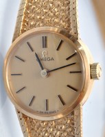 Lot 386 - Omega: a lady's 9ct. gold wristwatch and strap,...