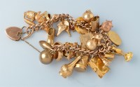 Lot 395 - A 19th Century yellow metal curb link charm...