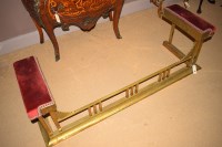 Lot 1188 - A Victorian brass club fender, red velour...