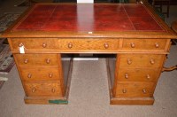 Lot 628 - An early 20th Century oak pedestal desk, inset...