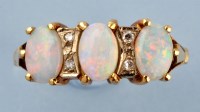 Lot 845 - An opal and diamond ring, the three oval opal...