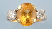 Lot 916 - A citrine and diamond ring, the oval facet cut...