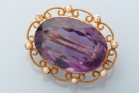 Lot 821 - An amethyst and seed pearl brooch, the oval...