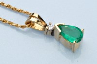 Lot 956 - An emerald and diamond pendant, the pear-cut...