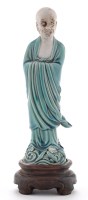 Lot 508 - Part biscuit and turquoise glaze figure of an...