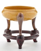 Lot 511 - Yellow and aubergine tripod of censer form, on...