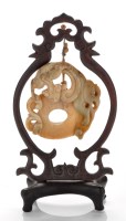 Lot 601 - Variegated brown jade 'chilong' pendant, with...