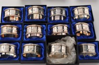 Lot 1055 - A set of twelve Elizabeth II napkin rings, by...