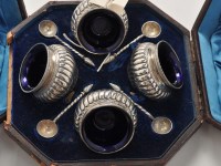 Lot 1138 - A set of four Victorian table salts and spoons,...