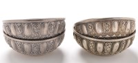 Lot 1161 - Four embossed white metal bowls, possibly...