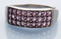 Lot 1226 - A pink diamond dress ring, set in three rows...