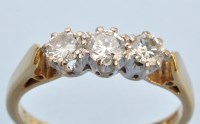 Lot 652 - A three stone diamond ring, the brilliant cut...