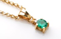 Lot 912 - An emerald and diamond set drop pendant, the...