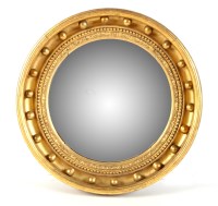 Lot 1057 - A Regency giltwood convex wall mirror, the...