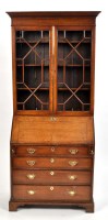 Lot 1130 - A George III oak bureau, the rectangular...