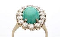 Lot 808 - A turquoise and diamond cluster ring, the oval...
