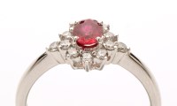 Lot 815 - A ruby and diamond cluster ring, the central...