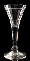 Lot 955 - Drawn plain wine glass, the trumpet bowl above...