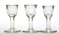Lot 1034 - Three plain stem firing glasses, of typical...