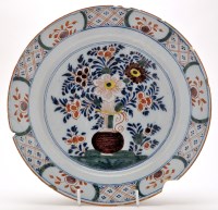 Lot 1076 - Delftware polychrome dish, with vase of...