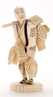 Lot 1300 - Japanese carved ivory figure of a trapper,...