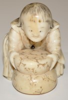 Lot 1302 - Japanese bone Netsuke, as a young boy grinding...