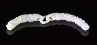Lot 45 - A carved jadeite pendant, the stone of pale...