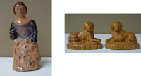 Lot 169 - A pair of recumbent dogs on oval bases, yellow...