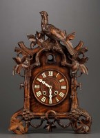 Lot 1260 - A carved cuckoo clock, with roman dial, two...
