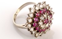 Lot 803 - A ruby and diamond cluster ring, made up of...