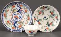 Lot 409 - A Famille Verte cup and saucer, painted with...