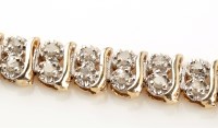 Lot 858 - A diamond double line bracelet, each of the...
