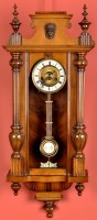 Lot 1069 - A 'Viennese' walnut wall clock, the circular...