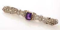 Lot 666 - An amethyst and diamond Art Deco style bow...
