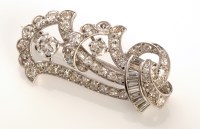 Lot 747 - An Art Deco style diamond brooch, of stylized...