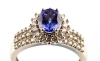 Lot 941 - A tanzanite and diamond cluster ring, the...